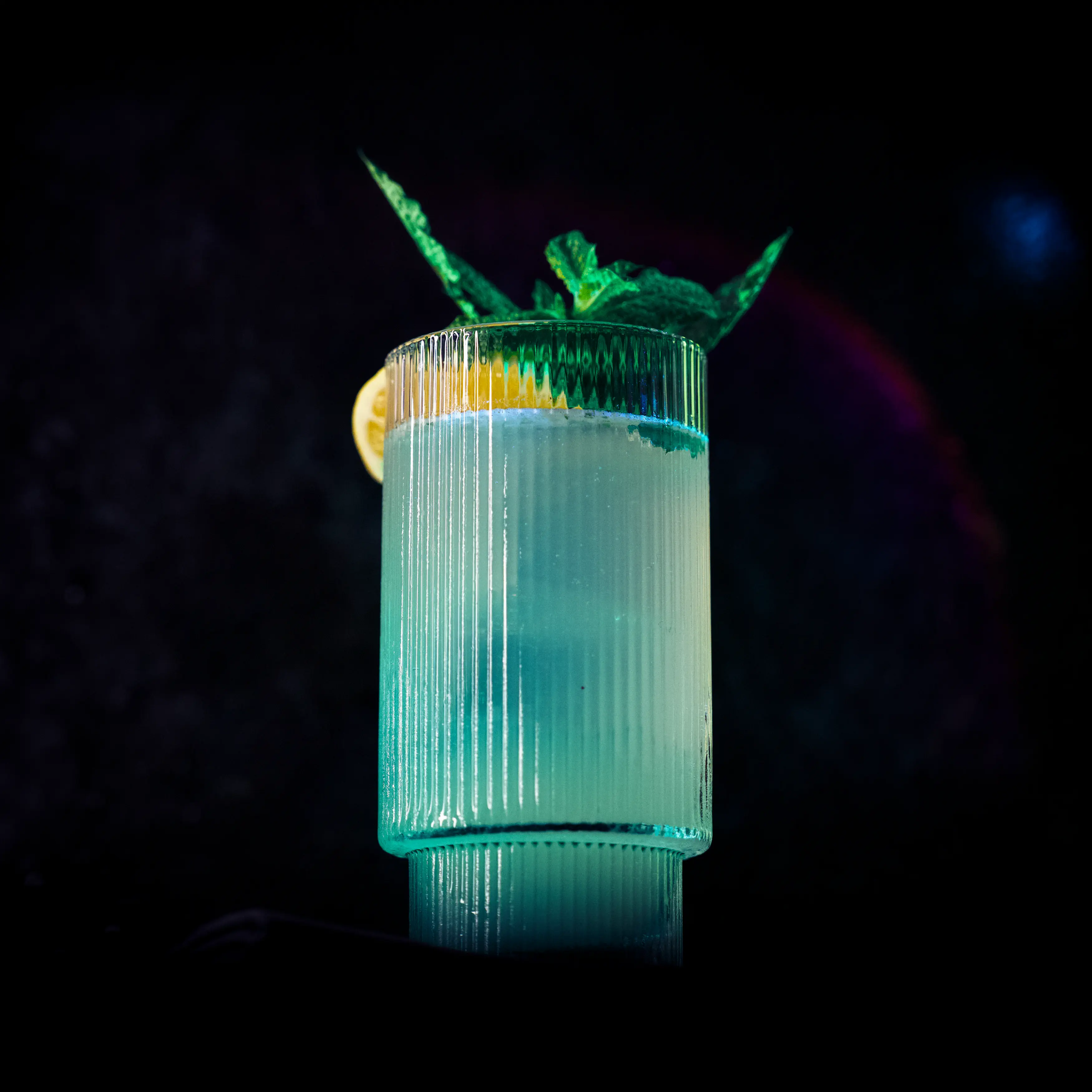 Moscow Mule in a ribbed highball glass with a citrus slice and mint.