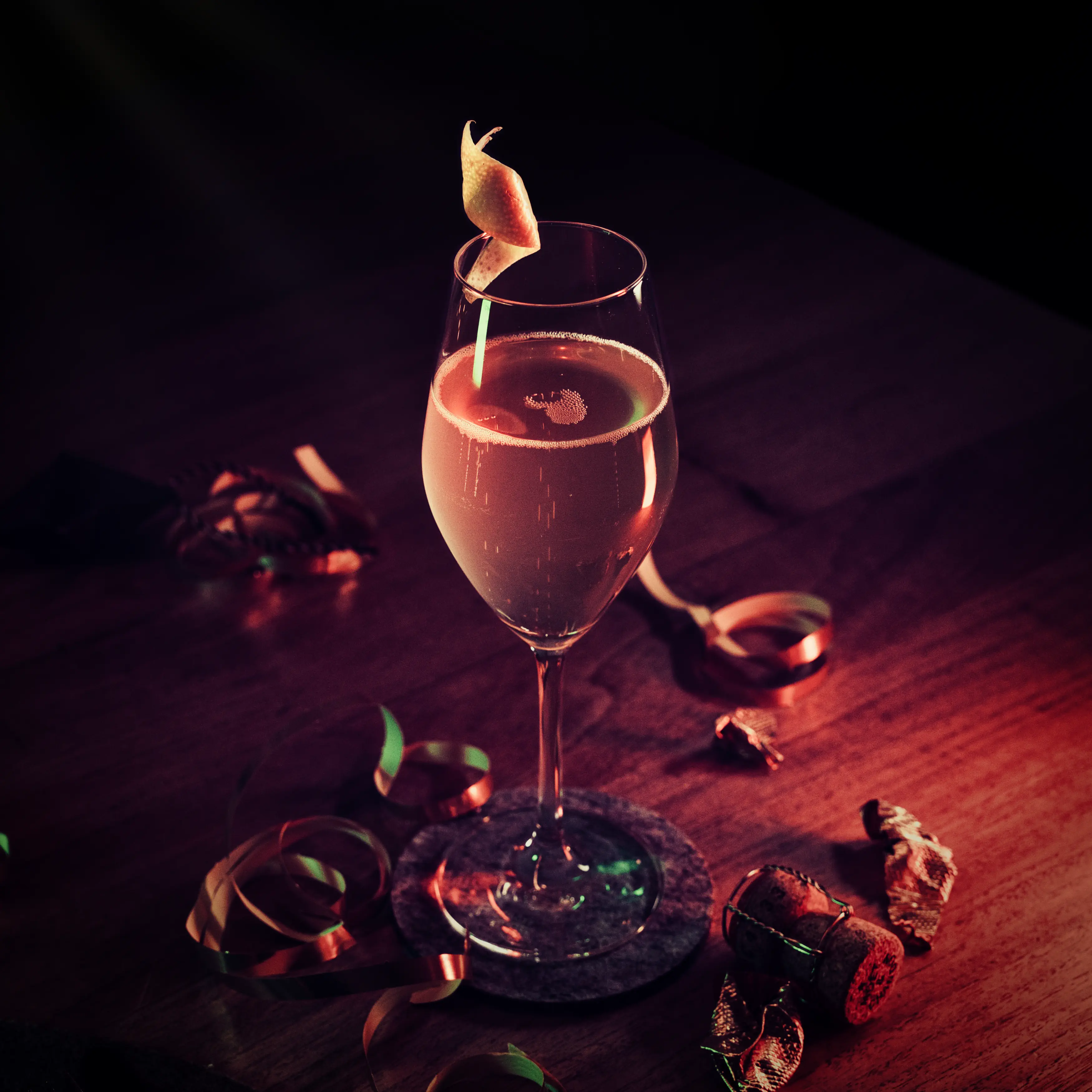 Golden Sex on the Beach cocktail in a stemmed glass with a citrus-peel garnish.